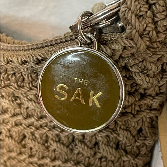 The Sak Crochet Shoulder Bag in Cognac color. Crochet Flower detail on zipper. - Picture 7 of 10